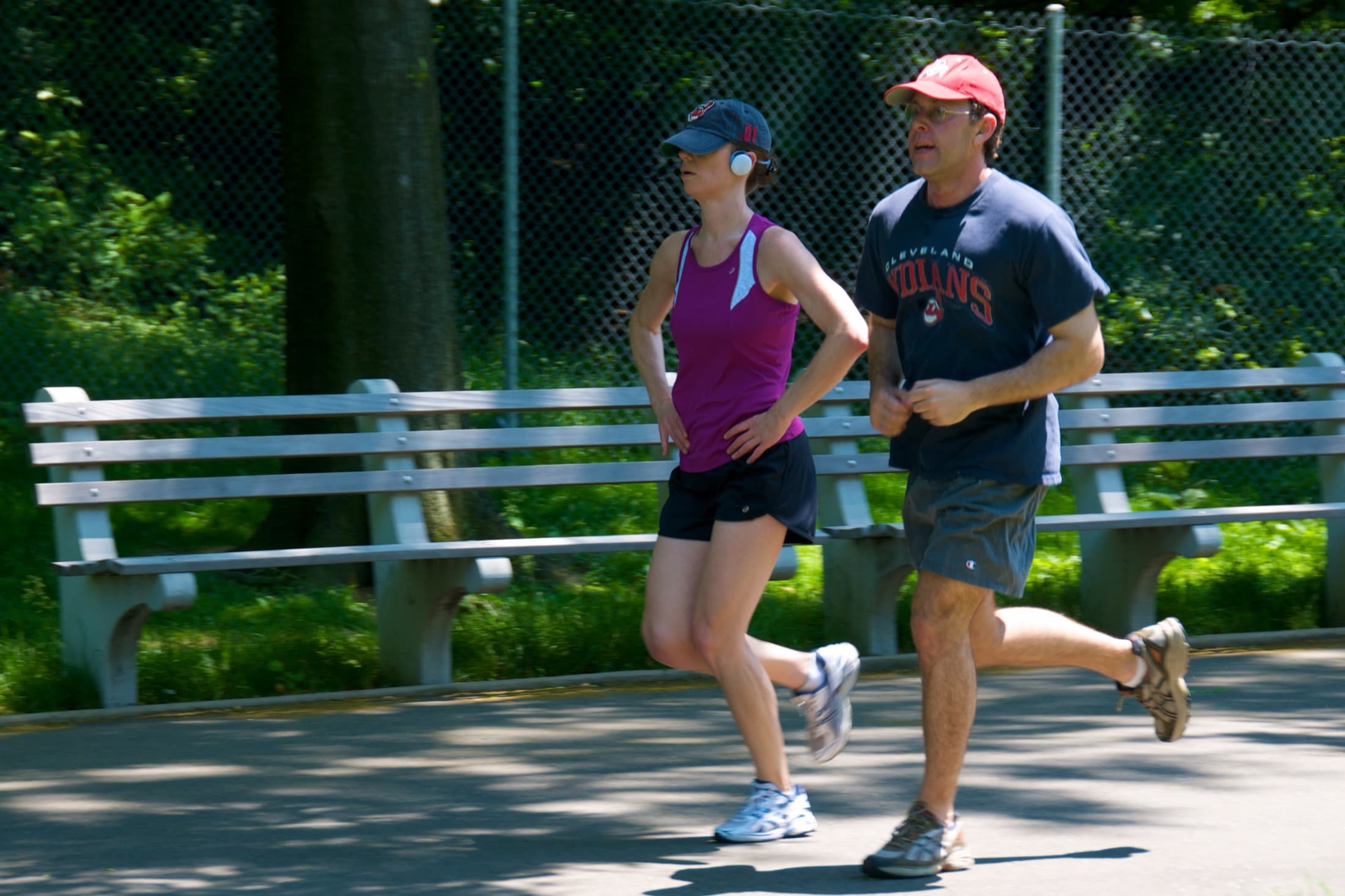Adult couple jogging outdoors on a city trail