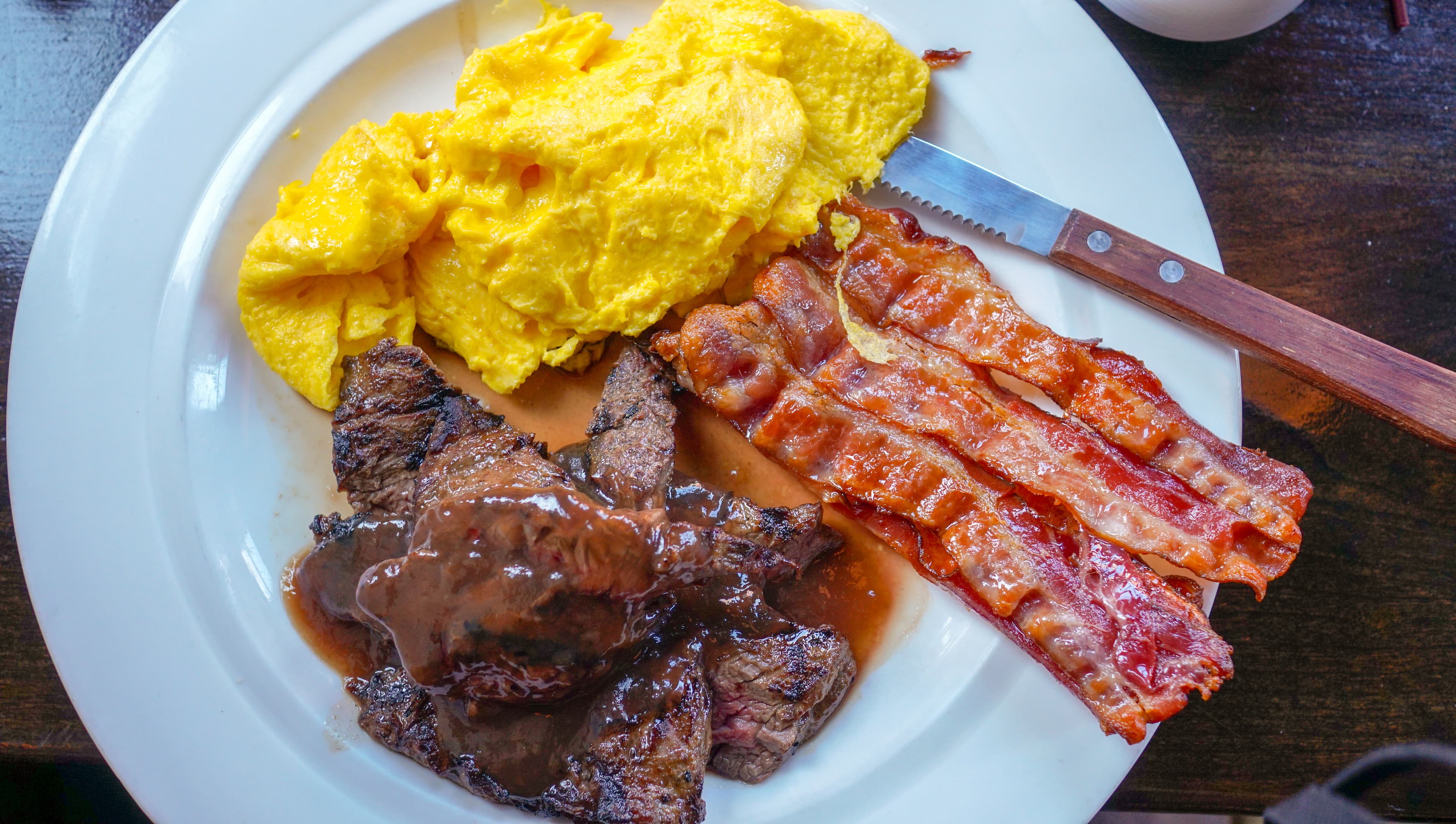 Low-carbohydrate breakfast with eggs, bacon, and steak